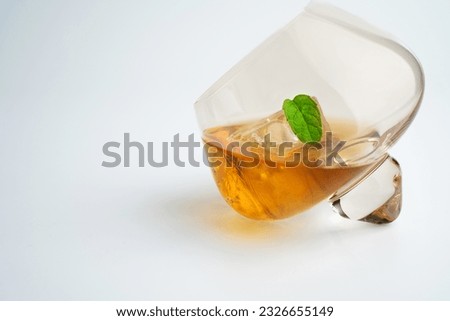 Cocktail drink whiskey on the rocks in rare glass isolated at white