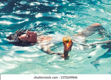 Cocktail Drinking In Summer Pool. Girl Drink Cocktail From Glass