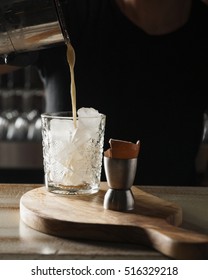 Cocktail With Eggs Poured In Glass With Ice With Egg Shell On The Side