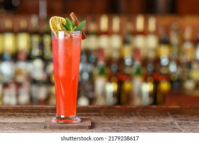 Cocktail Fruit Sling Long Drink On The Blurred Background Of The Bar Counter, Image For The Menu. Frozen Alcoholic Drink