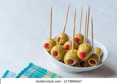 Cocktail Green Olives Stuffed with Red Paprika Pepper Served with Toothpick. - Powered by Shutterstock