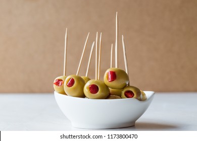 Cocktail Green Olives Stuffed with Red Paprika Pepper Served with Toothpick. - Powered by Shutterstock