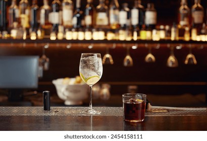 Cocktail with ice and lemon on wooden bar counter desk - Powered by Shutterstock