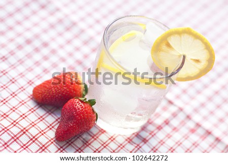 cocktail with ice, lemon and strawberry