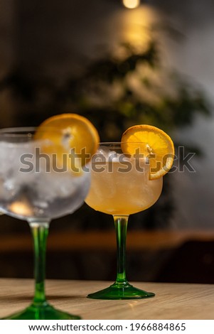 Cocktail with ice and orange on restaurant table