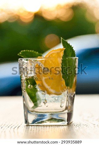 cocktail with lemon , ice and peppermint leaves 