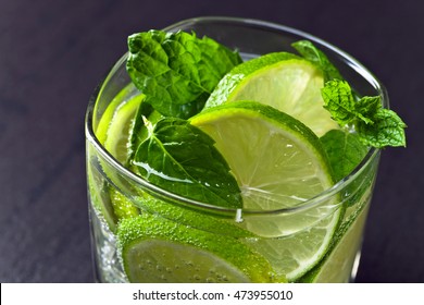 cocktail with lime , ice  and peppermint leaves 