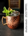 Cocktail made with vodka, moscow mule in metal glass. Bars and experiences.