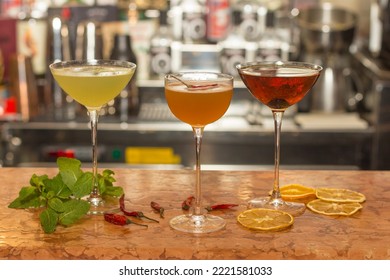 Cocktail Making, Close Up On A Bartender Table With Alcoholic Drinks For A Happy Hour Late Evening. No People Are Visible.