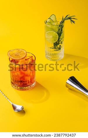 Cocktail Negroni and mojito cocktail on yellow background