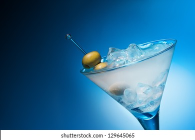 Cocktail with olives on blue background - Powered by Shutterstock