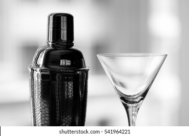 Cocktail shaker and martini glass with city background in elegant black and white - Powered by Shutterstock