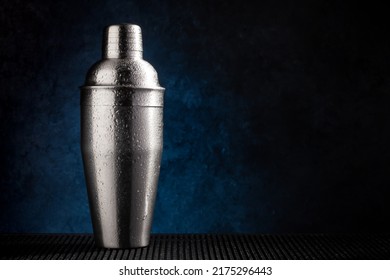 Cocktail shaker on dark background with copy space