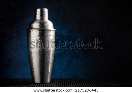 Cocktail shaker on dark background with copy space