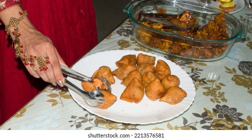 Cocktail Or Small Samosa In White Plate Serve In A Party. Beautiful Hand Picking By Tong. Selective Focus On Samosa.