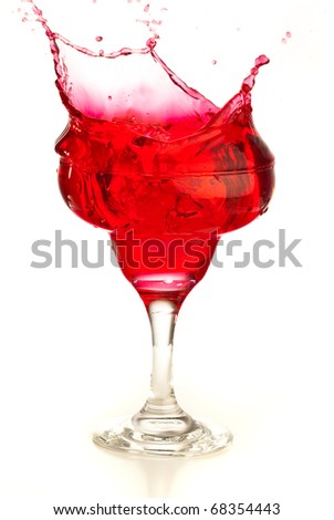 cocktail splashing into glass on a white background