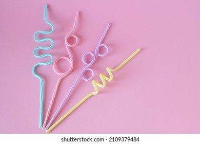 Cocktail straws Day. Drinking straws on a pink background. Summer cocktail party, a fun and happy holiday concept