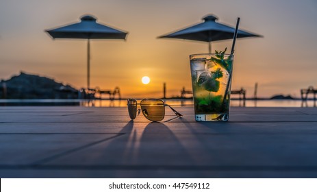 Cocktail with sunglasses near the swimming pool - Powered by Shutterstock