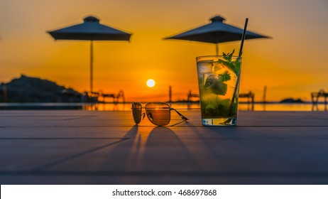 Cocktail with sunglasses near the swimming pool

