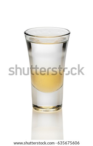 Cocktail with three layers of alcohol in shot glass isolated on white