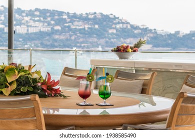 Cocktail time on table in super yacht board, summer time with super yachts and Monte-Carlo luxury city background. Luxury lifestyle on Monaco