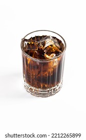 A Cocktail Of Whiskey And Cola Is Decorated With A Large Ice Cube. On A White Isolated Background.