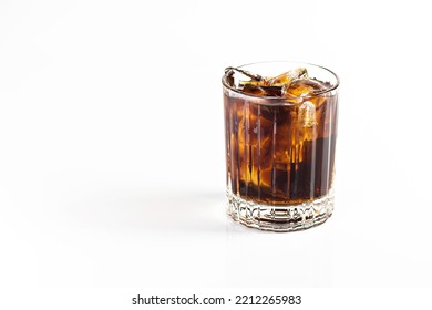 A Cocktail Of Whiskey And Cola Is Decorated With A Large Ice Cube. On A White Isolated Background.