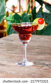 Cocktail Woowoo From Cherry, Lime, Mint, Cranberry Juice And Vodka Stands On The Old Wooden Table.