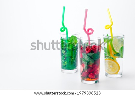 Similar – Infused water in bottles with drink straw and ingredients on white background, front view. Water Flavored with fruits, berries and herbs. Summer drinks. Healthy and clean detox beverages.