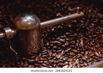 Cocoa beans roasting process with close-up of industrial machinery.