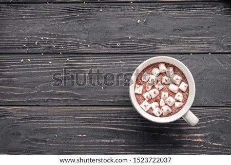 Cocoa chocolate cup with hot drink and white marshmallow on wood desk cozy background, cacao in mug on brown wooden rustic table, holiday coffee house shop, above top overhead view, copy space
