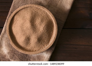 Cocoa or chocolate drink powder in bowl, photographed overhead with natural light (Selective Focus, Focus on the top of the chocolate powder)