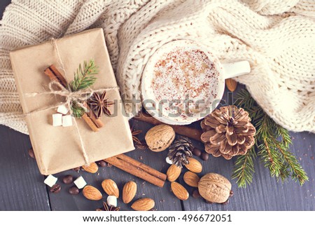 Cocoa, coffee  with marshmallows, fir branch, nuts, gift, cozy knitted blanket. Winter, New Year, Christmas still life.