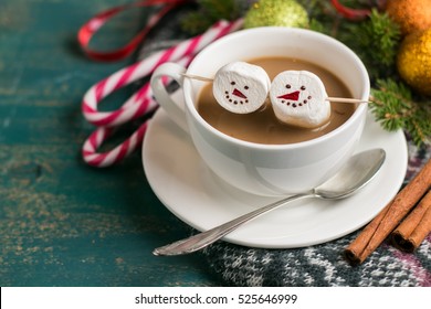 cocoa with a marshmallow snowman of a cup in the winter Christmas table - Powered by Shutterstock