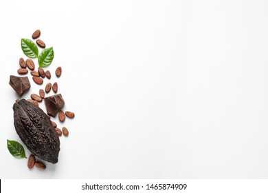 Cocoa Pod With Beans And Chocolate Pieces On White Background, Top View