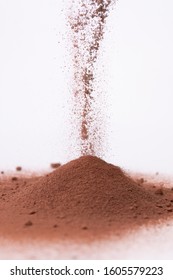 Cocoa powder explosion and falling with withe background