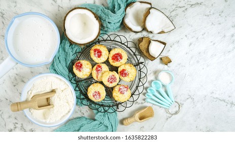 Coconut Baking Theme Flat Lay Creative Layout Overhead With Baked Macaroons, Coconut Flour, Milk, Oil, And Shredded Desiccated Coconut And Baking Utensils On Marble Table Top.