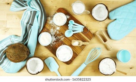 Coconut Baking Theme Flat Lay Creative Layout Overhead With Coconut Flour, Milk, Oil, And Shredded Desiccated Coconut And Baking Utensils On Modern Wooden Table.