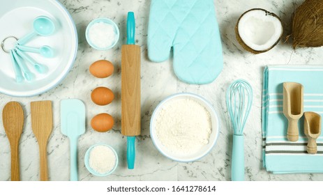 Coconut Baking Theme Flat Lay Creative Layout Overhead With Coconut Flour, Milk, Oil, And Shredded Desiccated Coconut And Baking Utensils On Marble Table Top.