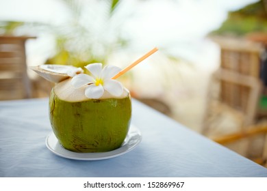 Coconut, beach cafe, plumeria on table with blurry background