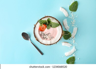 Coconut Bowl With Pink Yogurt On Color Background