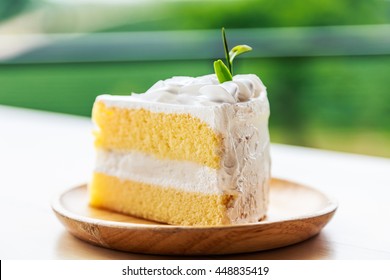 Coconut cream cake on wooden plate