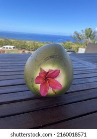 Coconut Decorated With A Flower Overlooking Maui Scenery 