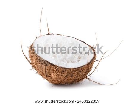 Coconut flakes in nut shell isolated on white