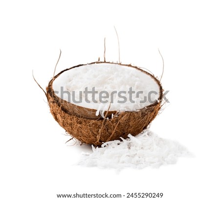 Coconut flakes in nut shell isolated on white