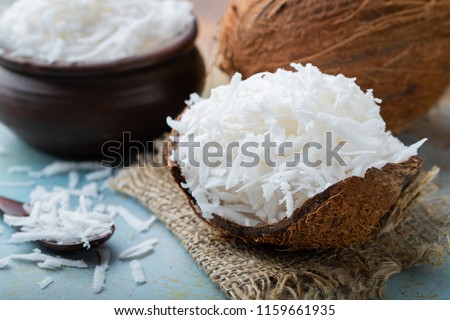 Coconut flakes in a shell on a blue background