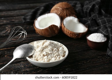 Coconut Flour In Ceramic Bowl On Wooden Table