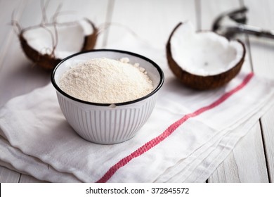 Coconut Flour In Old Bowl On Wooden Table