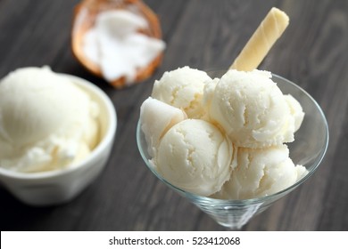 Coconut ice cream is sweet food on wood background.