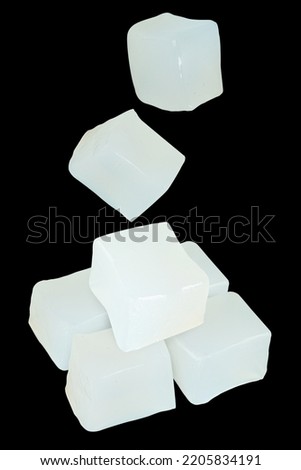 Coconut jelly cubes isolated on black background